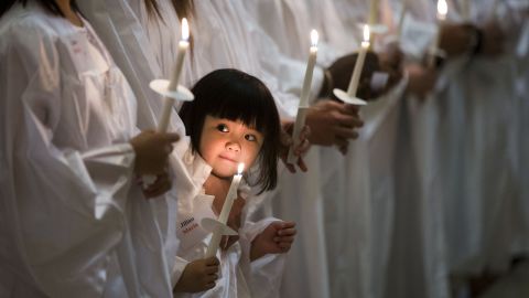 <strong>April 4:</strong> Jillian Nguyen, 3, stands with others as they are baptized into the Catholic faith in Philadelphia.