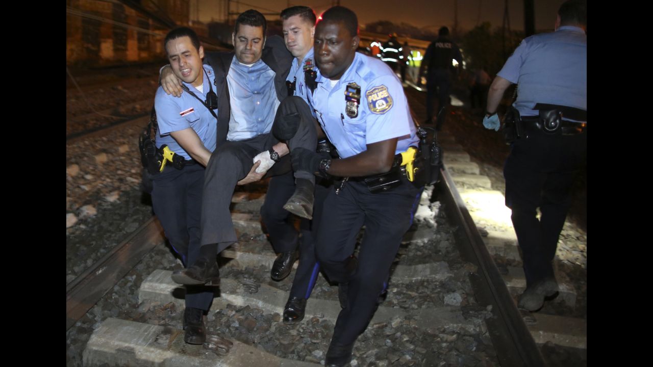 <strong>May 12:</strong> Emergency personnel help a passenger at the scene of an Amtrak crash in Philadelphia. At least eight people were killed and more than 200 were injured when <a href="http://www.cnn.com/2015/05/13/homepage2/gallery/philadelphia-amtrak-crash/index.html" target="_blank">the train derailed</a> on its way from Washington to New York.