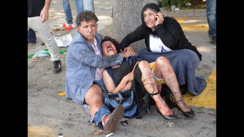 <strong>October 10: </strong>People try to help an injured woman after multiple explosions at a peace rally in Ankara, Turkey. <a href="http://www.cnn.com/2015/10/14/middleeast/turkey-ankara-blasts-investigation/" target="_blank">There were two explosions</a> during the rally, which called for an end to the renewed conflict between the Kurdistan Workers' Party and the Turkish government. At least 99 people were killed, officials said, and more than 240 were injured.