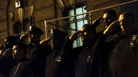 <strong>October 21:</strong> New York City police officers salute as the body of Officer Randolph Holder, 33, is taken away in an ambulance. <a href="http://www.cnn.com/2015/10/21/us/new-york-police-officer-killed/" target="_blank">Holder had been fatally shot</a> in the line of duty.