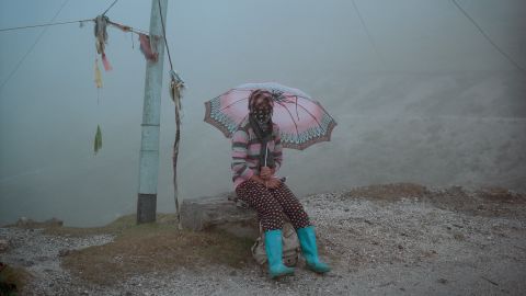 <strong>September 24: </strong>A person sits by the road near Sela Pass, a mountain pass in India's Arunachal Pradesh state.