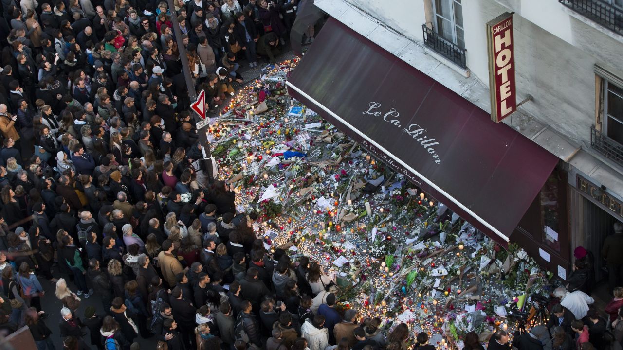 <strong>November 15:</strong> A large crowd gathers to lay flowers and candles in front of the Carillon restaurant, one of the establishments in Paris targeted by terrorists in the November 13 attacks.