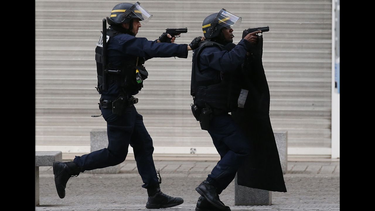 <strong>November 18:</strong> Armed police raise their guns during an operation in the Paris suburb of Saint-Denis. French special forces <a href="http://www.cnn.com/2015/11/18/world/gallery/french-raid-in-saint-denis/index.html" target="_blank">raided a building in Saint-Denis,</a> looking for those behind the recent terrorist attacks in Paris. The hours-long ordeal ended with at least two suspects dead and eight detained.