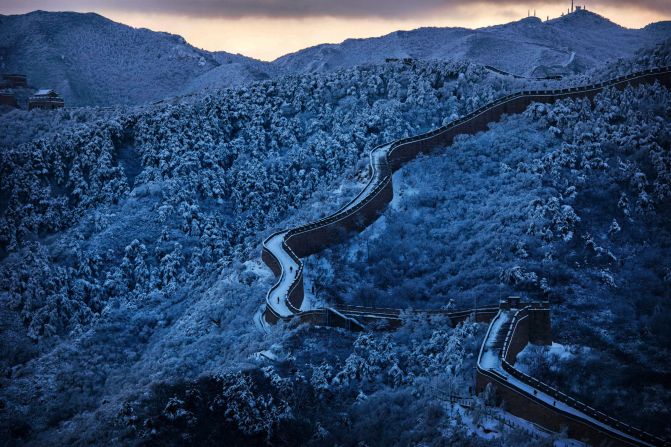 Snow blankets the Great Wall at twilight near Beijing, China on November 23, 2015.