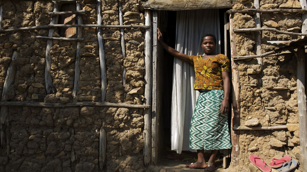 Christina, 14, outside her house where she lives with her husband and  mother-in-law in Tanzania. She was married at 13. 