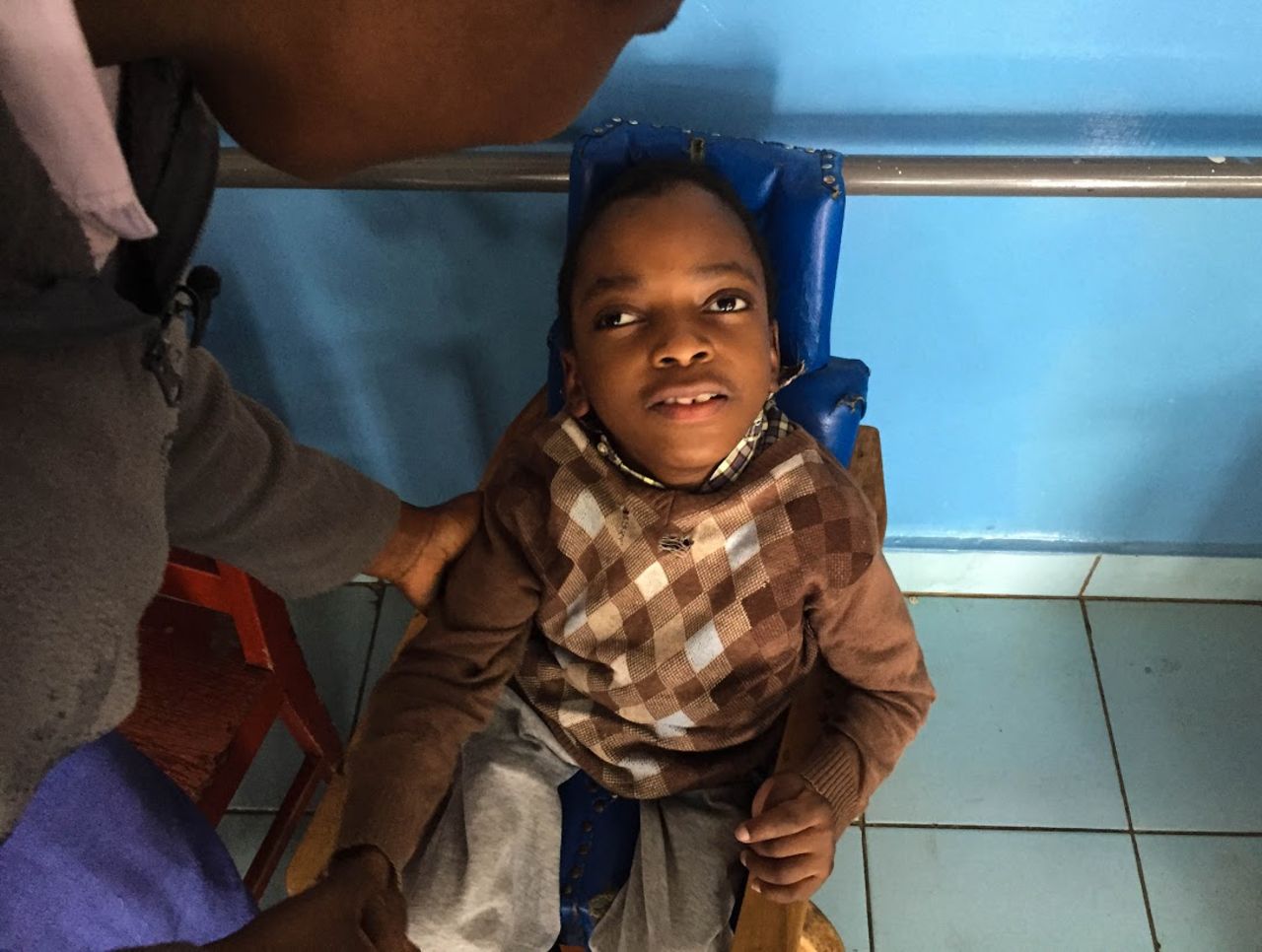Killeen helped found Songa Mbele, a school that cares for kids with disabilities. The mother of Zain Modeitsi, seen here, used to have to leave him at home alone in order to work.