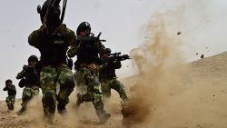 KASHGAR, CHINA - AUGUST 17: (CHINA OUT) Soldiers of Xinjiang Armed Police Frontier Corps get drill in gobi desert of Yecheng County on August 17, 2015 in Kashgar, Xinjiang Uygur Autonomous Region of China. (Photo by ChinaFotoPress/ChinaFotoPress via Getty Images)