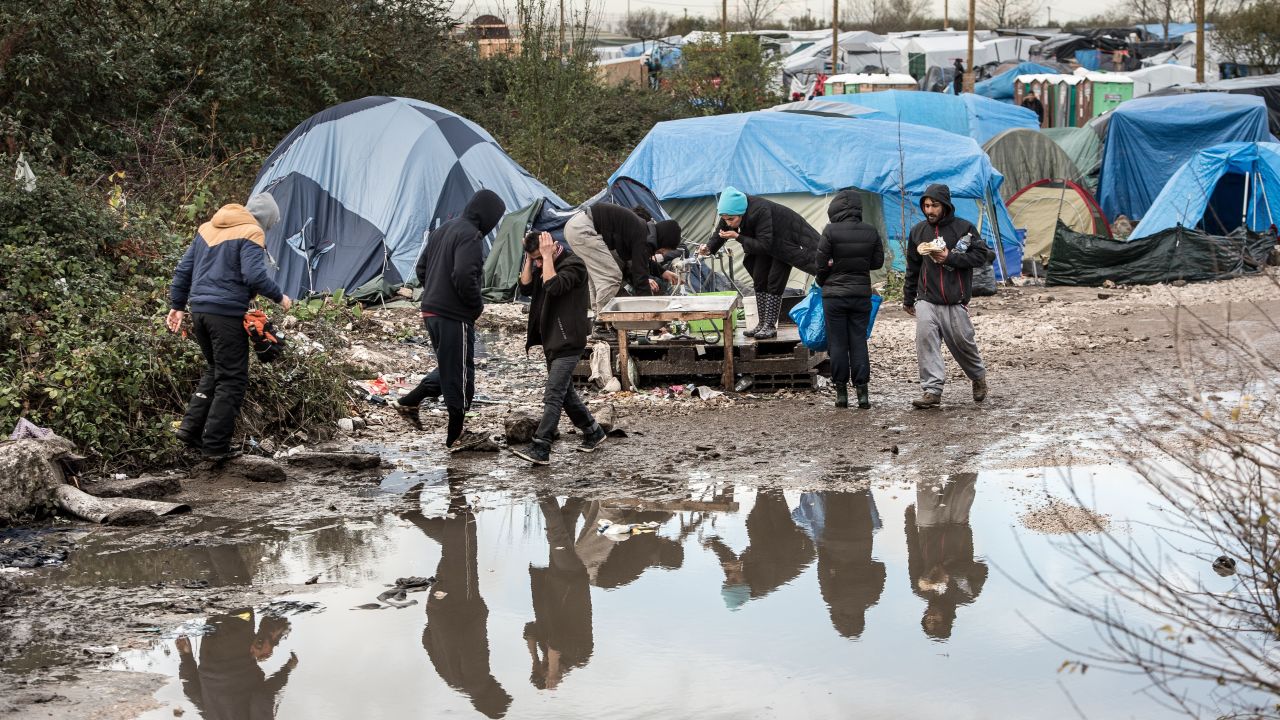 Migrants and refugees live in squalid conditions in the migrant camp known as "The Jungle."