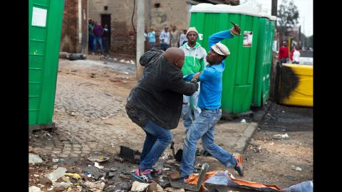 <strong>April 18:</strong> Mozambican Emmanuel Sithole, left, was walking down a street in Johannesburg's Alexandra Township when four men surrounded him. Sithole pleaded for mercy, but it was already too late. The attackers bludgeoned him with a wrench and stabbed him with knives, killing him in broad daylight. <a href="http://www.cnn.com/2015/04/20/africa/south-africa-xenophobia-killing-photos/" target="_blank">Photographer James Oatway was nearby</a> and captured it all on his camera. It was the morning after a night of unrest that saw foreign-owned shops looted and destroyed. At least seven people were killed in xenophobic violence against poorer immigrants.