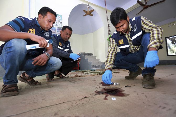 Investigators check the scene of a mosque attack Friday, November 27, in northern Bangladesh's Bogra district. <a href="index.php?page=&url=http%3A%2F%2Fwww.cnn.com%2F2015%2F11%2F27%2Fasia%2Fbangladesh-isis-attack-claim%2Findex.html" target="_blank">ISIS has claimed responsibility for the attack</a> that left at least one person dead and three more wounded.