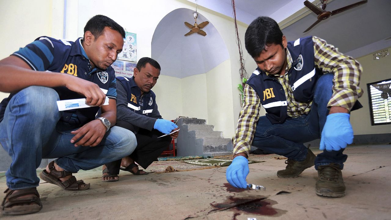 Investigators inspect the scene of an attack at a mosque that ISIS is claiming responsibility for.