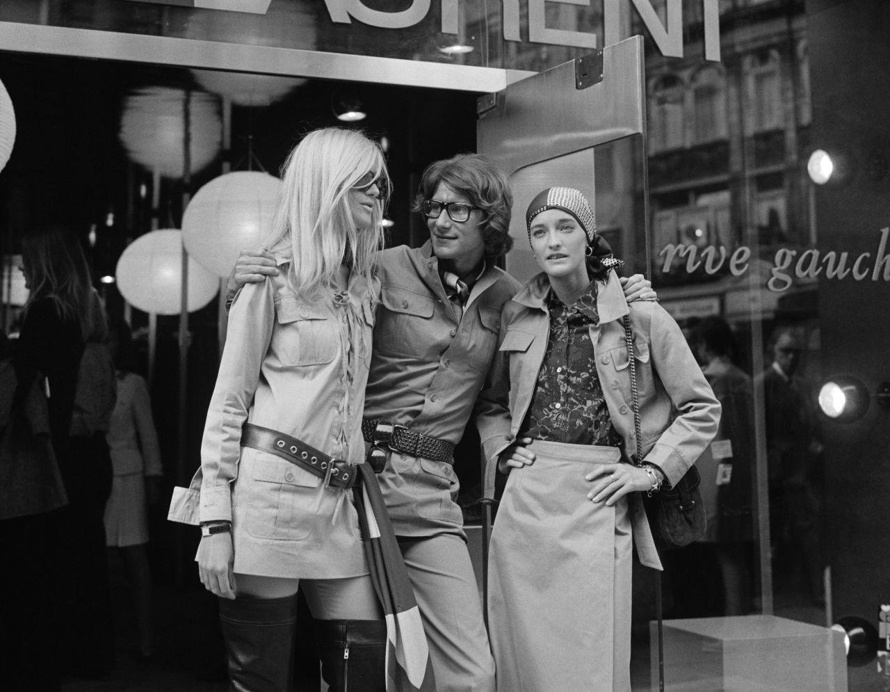 Yves Saint Laurent was at the creative helm of Christian Dior before branching out to start his own eponymous label in 1960. (Pictured: Yves Saint with friends and muses Betty Catroux and Loulou de la Falaise outside of his Paris Rive Gauche shop, 1969)