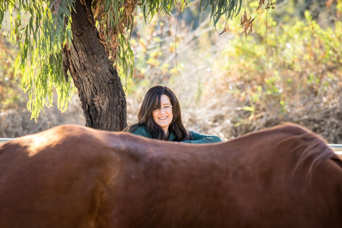 May interacts with a horse at the Ortega Center.