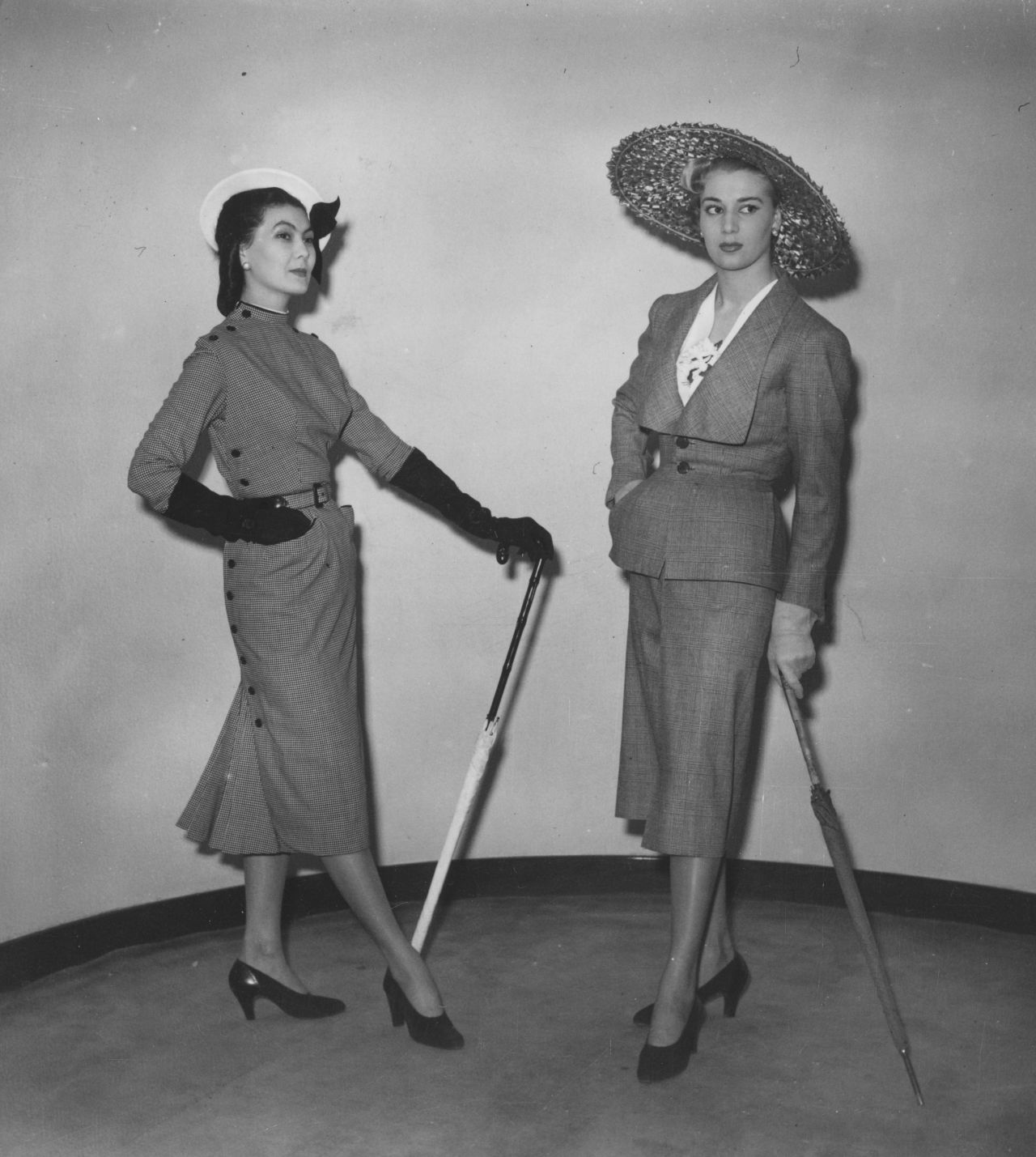 "His February 1947 collection's signature rebelled against wartime uniforms, austerity and fabric restrictions — the waist was cinched, calves were shown and busts were celebrated," says Gaultier. (Pictured: Models wear Christian Dior designs at London's Savoy Hotel, 1950)
