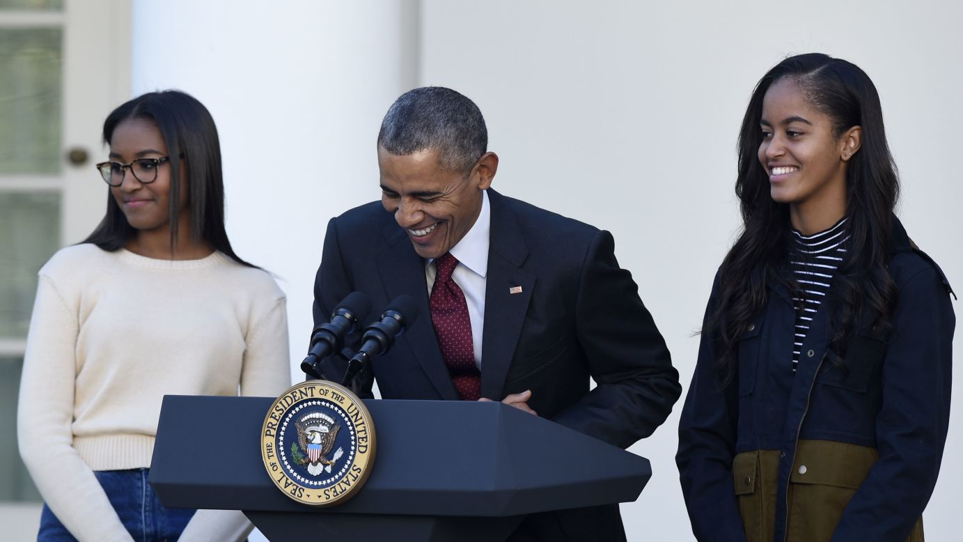 President Barack Obama -- with his daughters Sasha, left, and Malia -- laughs about pardoning a Thanksgiving turkey during a ceremony at the White House on Wednesday, November 25. "It is hard to believe that this my seventh year of pardoning a turkey," he said. "Time flies, even if turkeys don't."