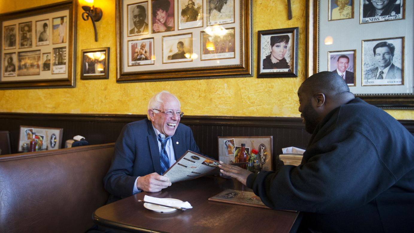 U.S. Sen. Bernie Sanders, who is seeking the Democratic Party's nomination for president, sits at an Atlanta cafe with rapper Killer Mike on Monday, November 23. The rapper introduced Sanders at a campaign event later in the evening.