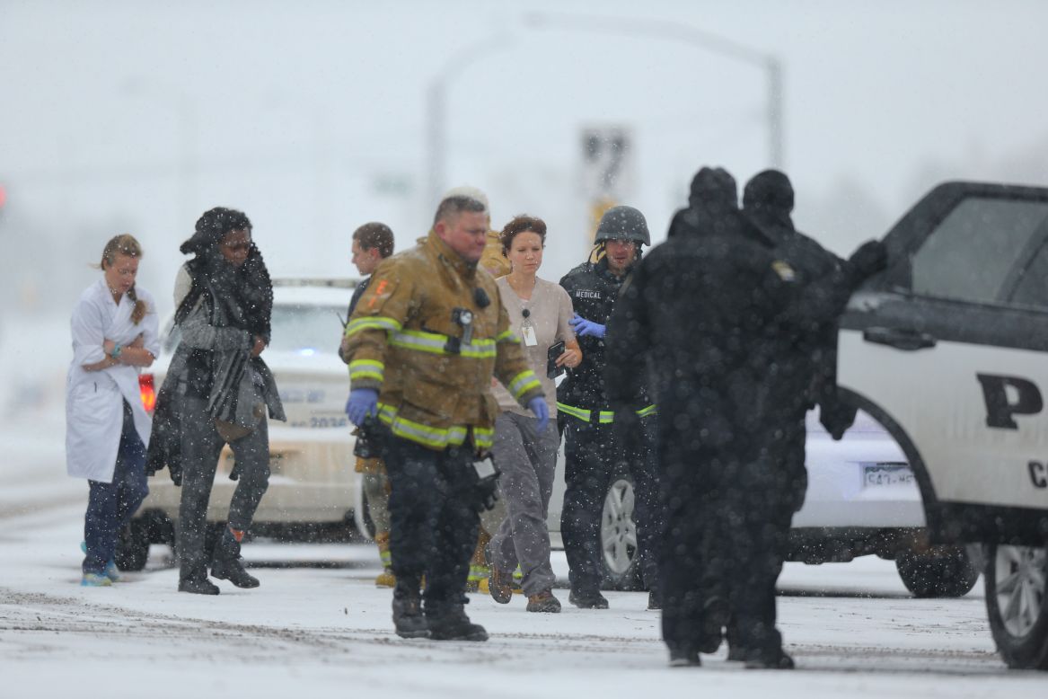 People are escorted to an ambulance during the standoff.