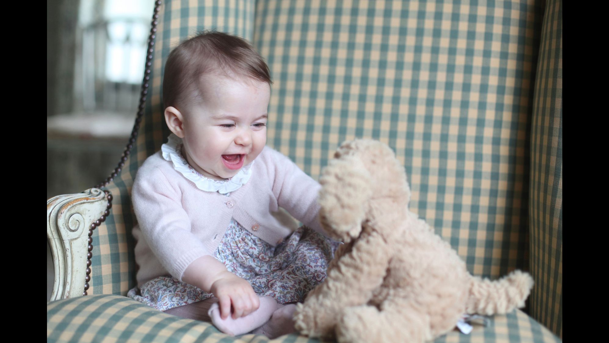 Princess Charlotte plays with a stuffed dog in this photo taken by her mother in November 2015.