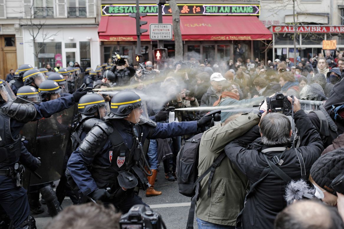 Police fight with activists during a protest ahead of the 2015 Paris Climate Conference at the Place de la République.