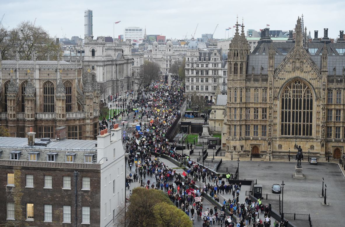Climate change demonstrators march to demand curbs to carbon pollution in London.