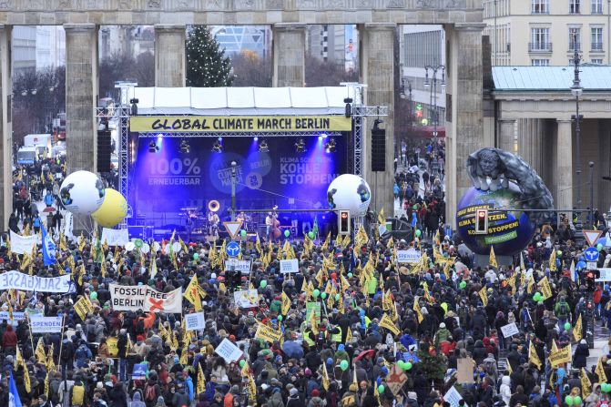 Climate activists march in front of the Brandenburger Tor in Berlin.
