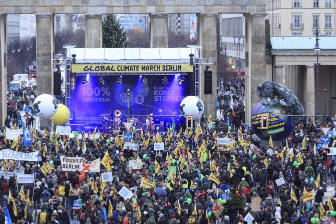 Climate activists march in front of the Brandenburger Tor in Berlin. 