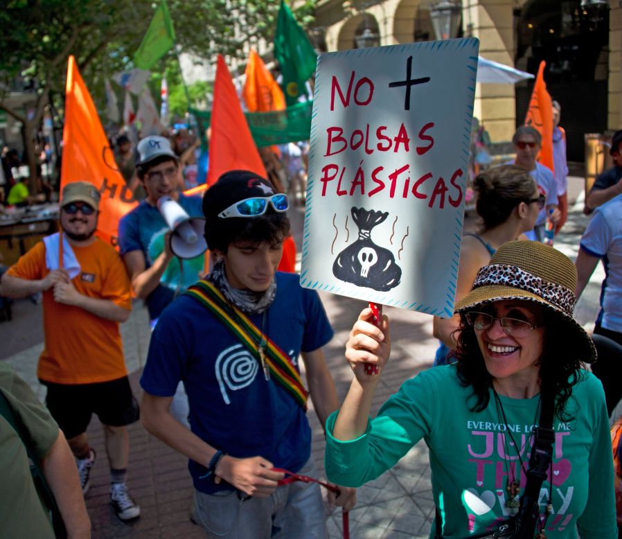 A woman holds a sign reading "No more plastic bags" during a march in Santiago, Chile. 