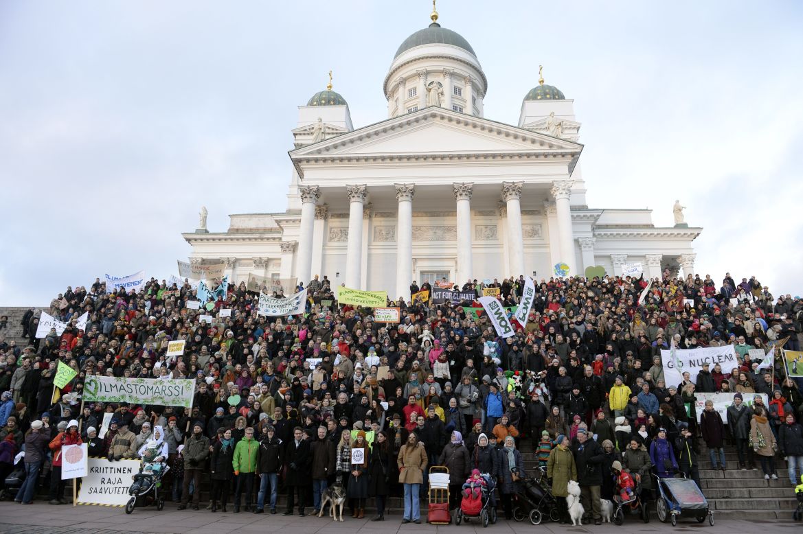 Climate march participants gather in front of the Helsinki Cathedral in Helsinki, Finland.