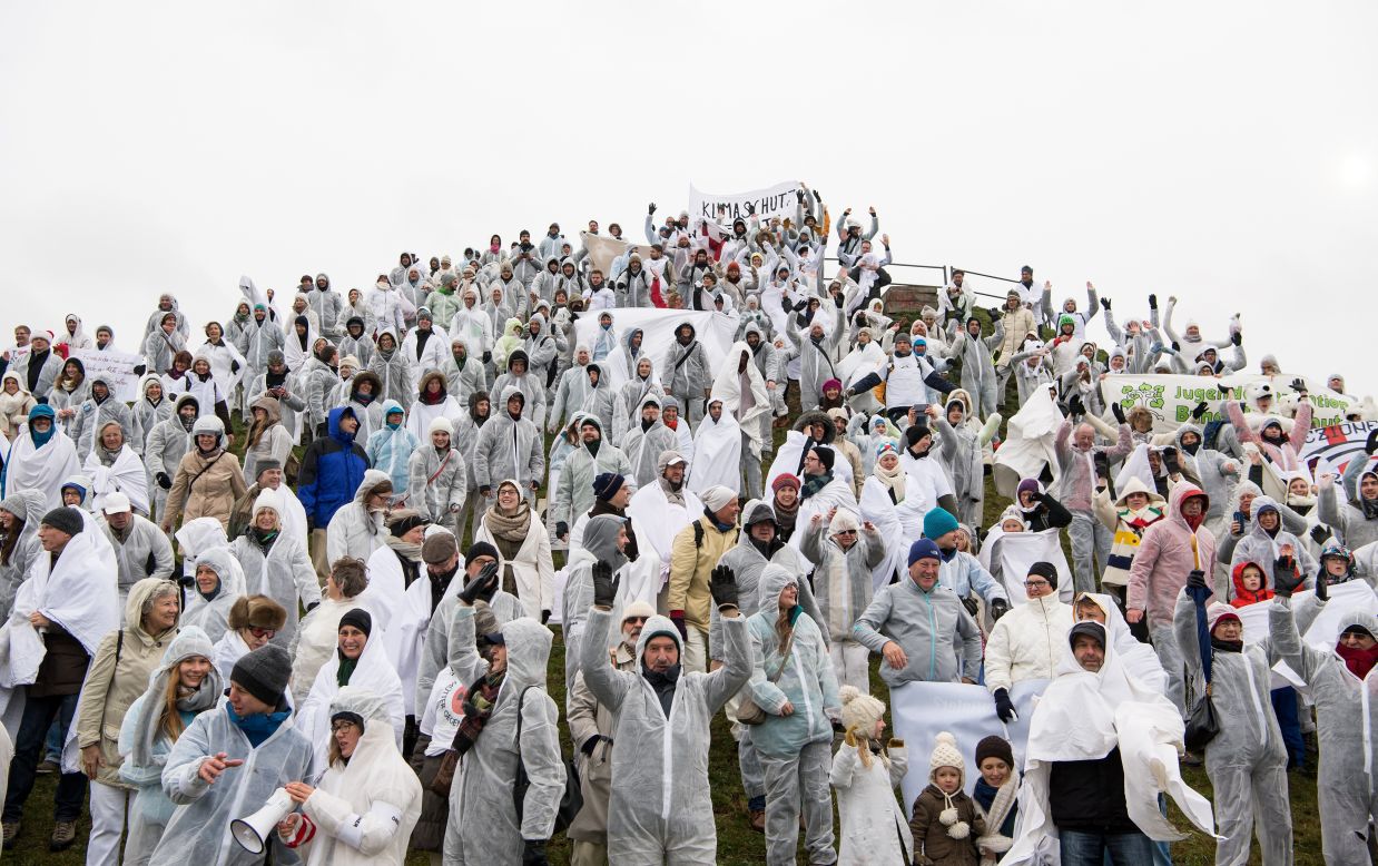 People dressed in white crowd form a human glacier in Munich, Germany.