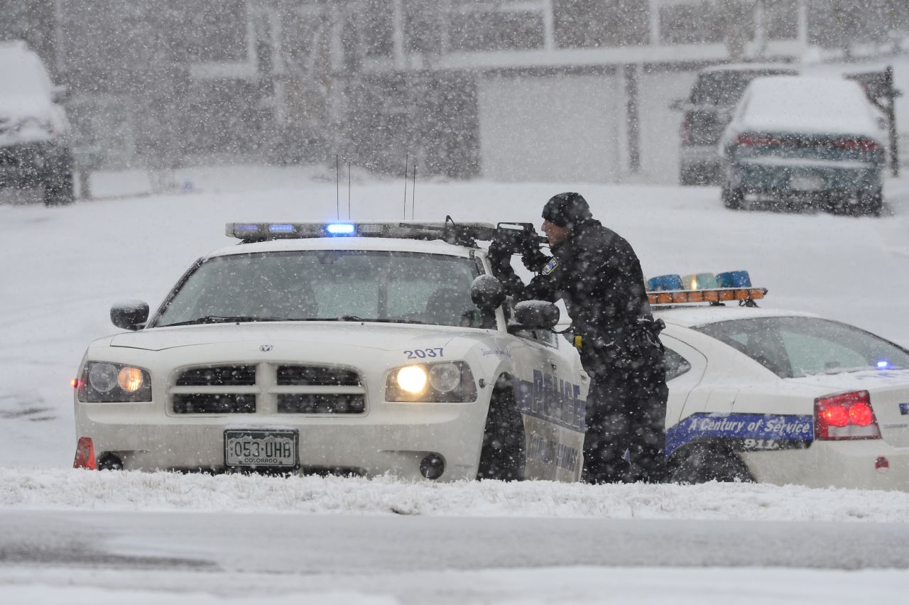  An officer waits at an intersection near the scene of a shooting.