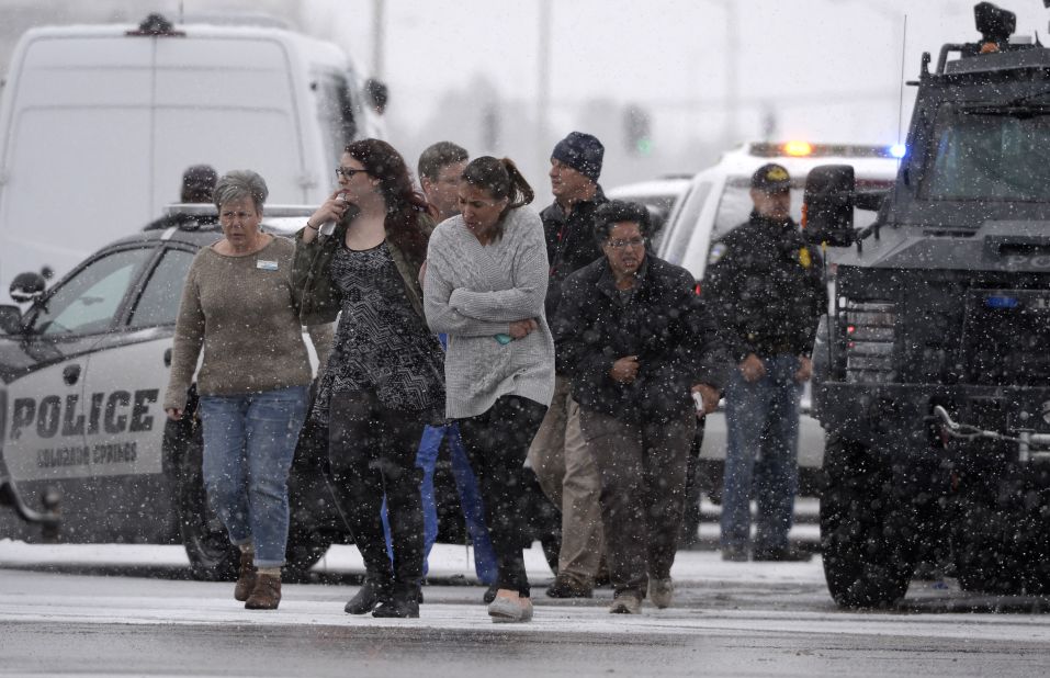 People are helped to safety. It was not immediately clear at the time of the attack whether Planned Parenthood was the target of the shooting.