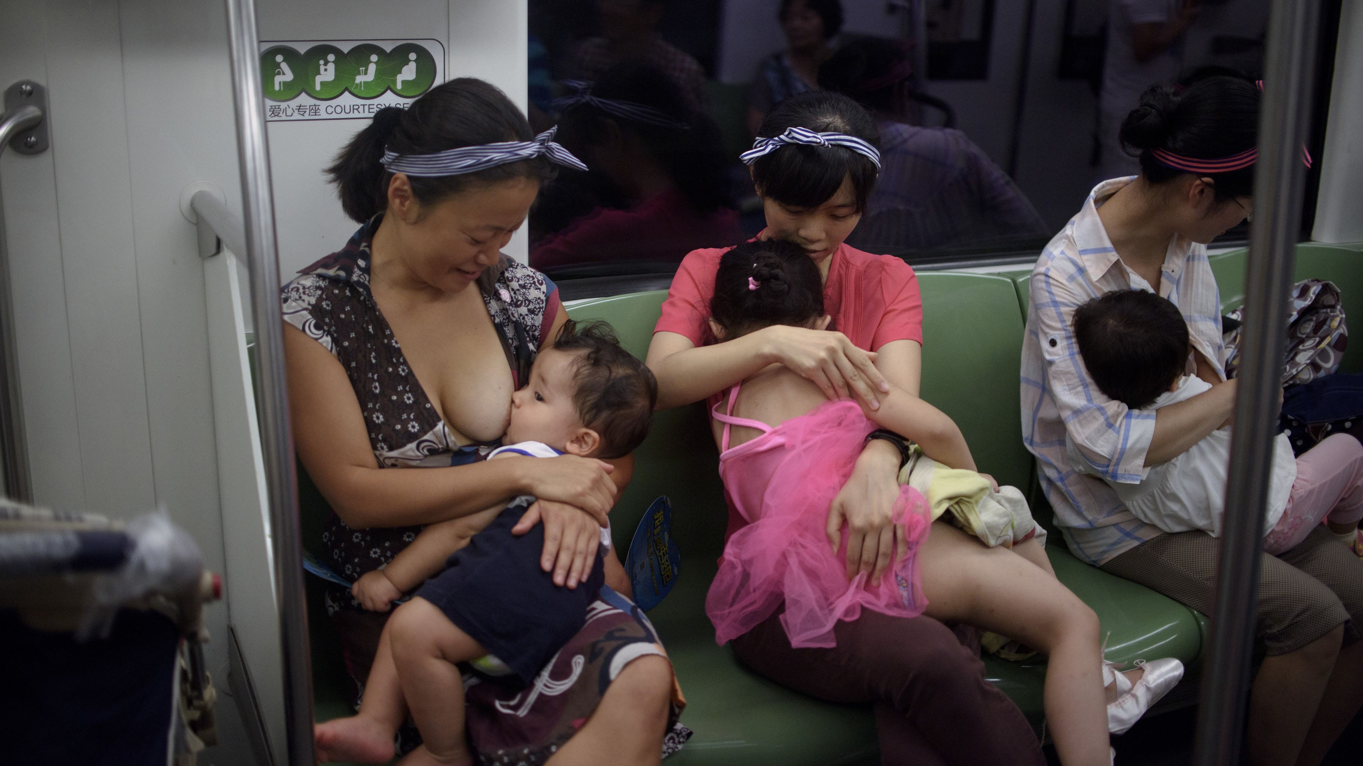 Mothers breastfeed their babies in a subway during an event of the world breastfeeding week on August 1, 2015.  