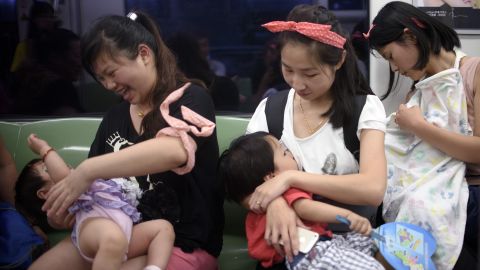 Mothers breastfeed their babies in a Beijing subway during an event celeberating the World Breastfeeding Week on August 1, 2015.