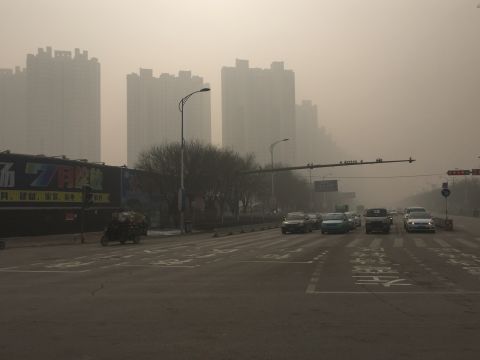 Roads and buildings in Baoding, China's most polluted city, are cloaked in thick smog on November 30, where the air quality index (AQI) has reached a 'hazardous' level.