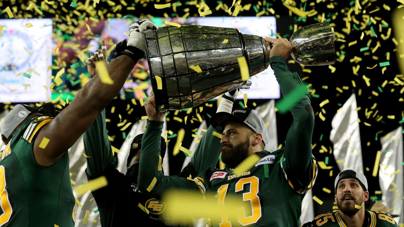 Edmonton quarterback Mike Reilly (No. 13) holds the Grey Cup after the Eskimos defeated Ottawa to win the Canadian Football League title on Sunday, November 29. It's Edmonton's 14th Grey Cup victory.