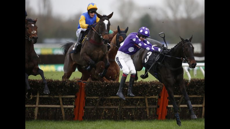 Aidan Coleman falls from his horse, Acajou Des Bieffes, during a hurdle race in Newbury, England, on Thursday, November 26.