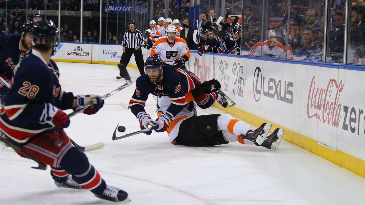 Jarret Stoll of the New York Rangers falls over Chris VandeVelde of the Philadelphia Flyers during an NHL game in New York on Saturday, November 28.