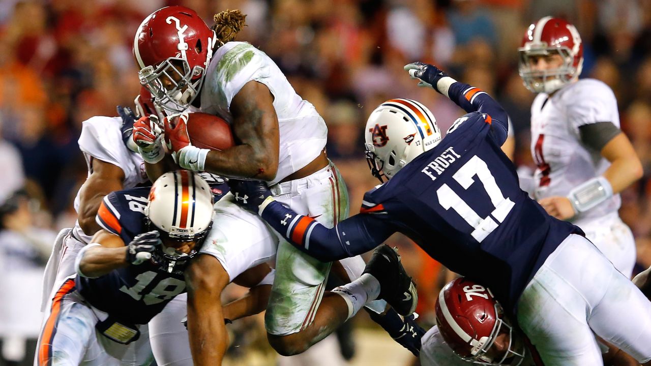 Alabama running back Derrick Henry blasts through Auburn defenders during the Iron Bowl rivalry game on Saturday, November 28. Henry ran for 271 yards and a touchdown as the Crimson Tide won 29-13 in Auburn, Alabama.