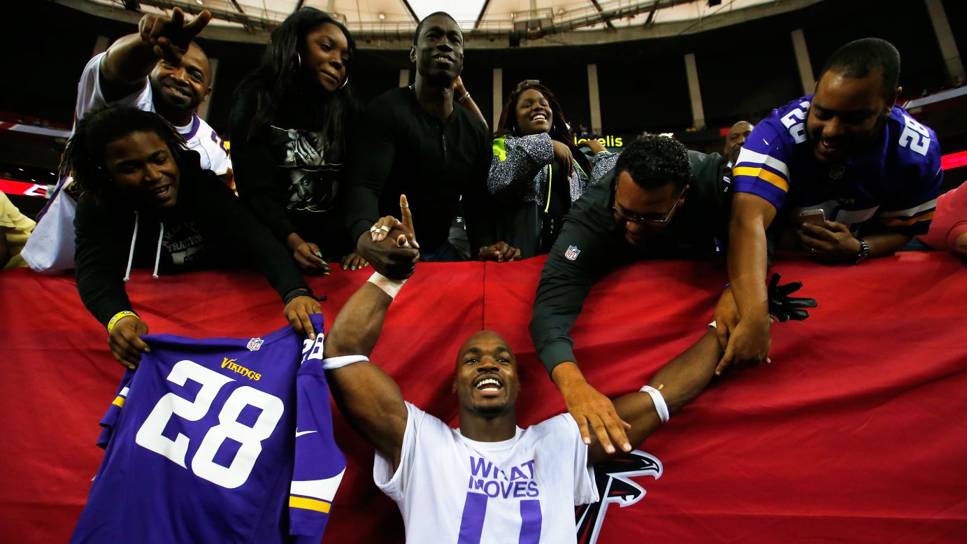Adrian Peterson celebrates with fans in Atlanta after he and the Minnesota Vikings defeated the Atlanta Falcons 20-10 in an NFL game Sunday, November 29.