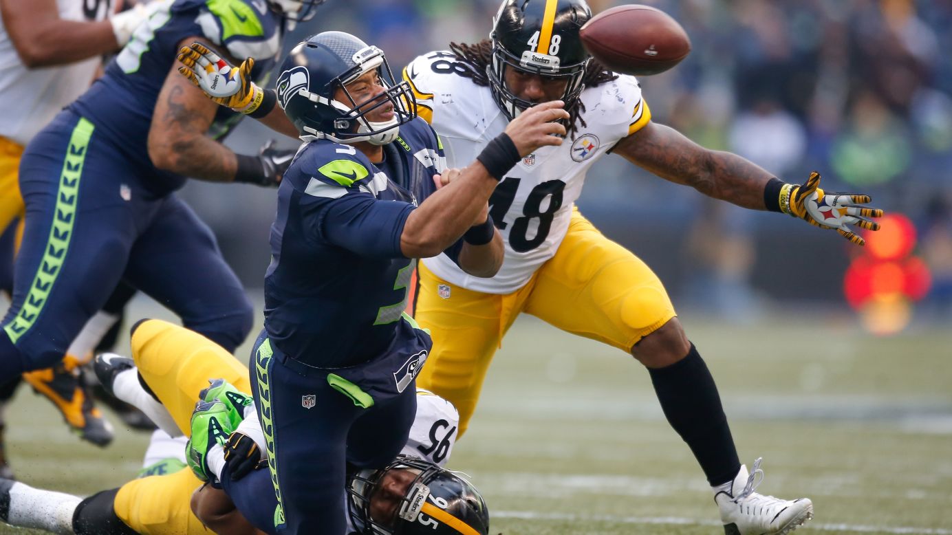 Seattle quarterback Russell Wilson is sacked by Pittsburgh's Jarvis Jones during an NFL game in Seattle on Sunday, November 29. Wilson threw five touchdowns, however, to help lead the Seahawks to a 39-30 victory.