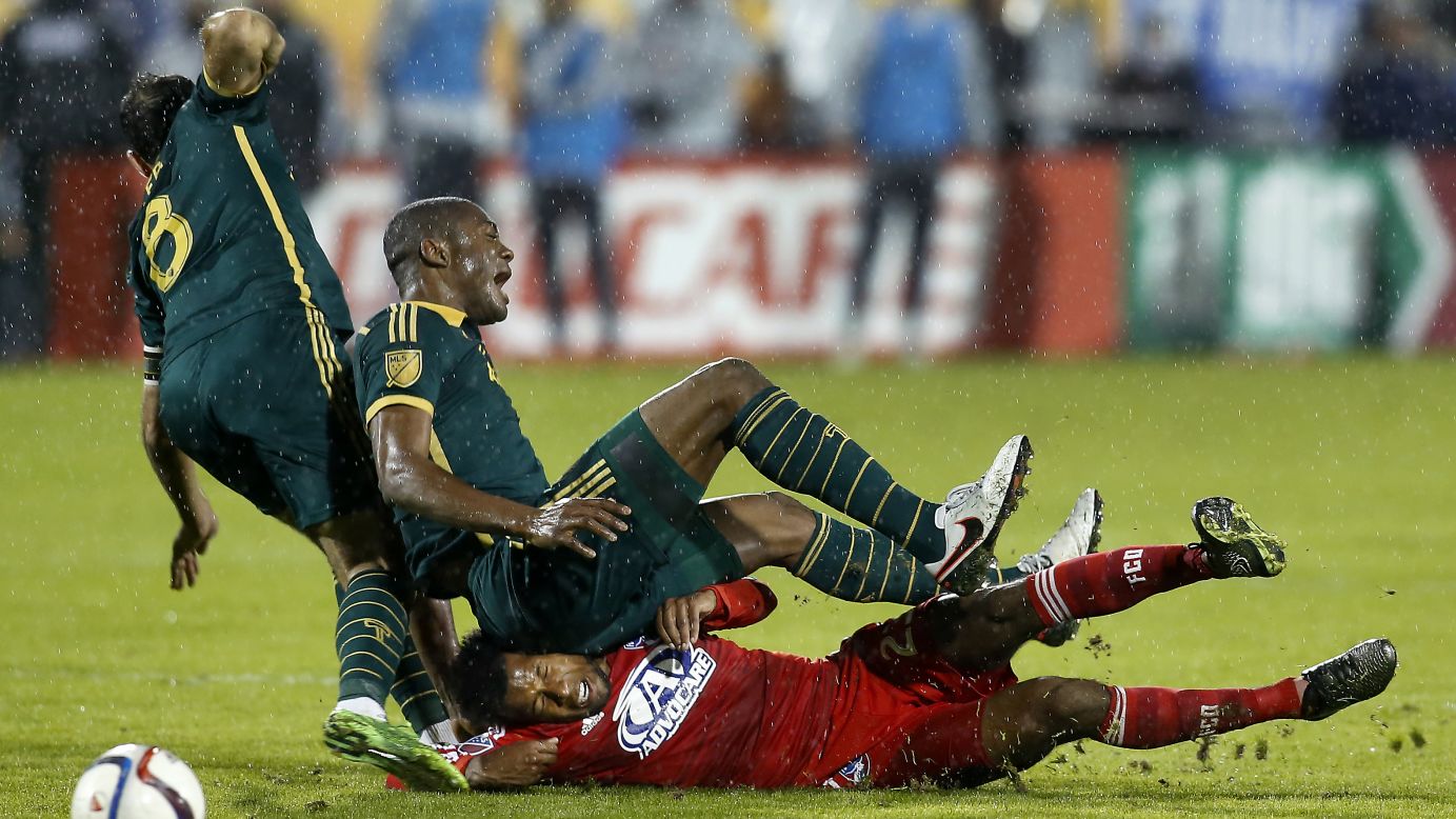 Portland forward Fanendo Adi lands on FC Dallas' Kellyn Acosta after a tackle Sunday, November 29, in the second leg of the MLS Western Conference championship. The match in Frisco, Texas, ended 2-2, but Portland's 3-1 victory in the first leg ensured that it would advance to the league final to play Columbus.