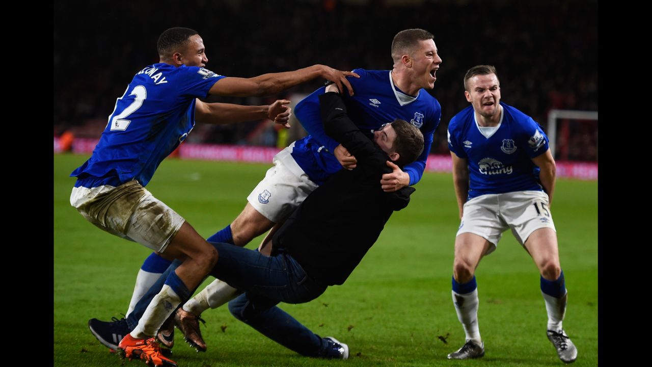 Everton's Ross Barkley is congratulated by a fan who ran onto the field during a Premier League match in Bournemouth, England, on Saturday, November 28. Barkley's late goal appeared to have won Everton the match against Bournemouth, but Junior Stanislas tied the score in the match's dying moments.