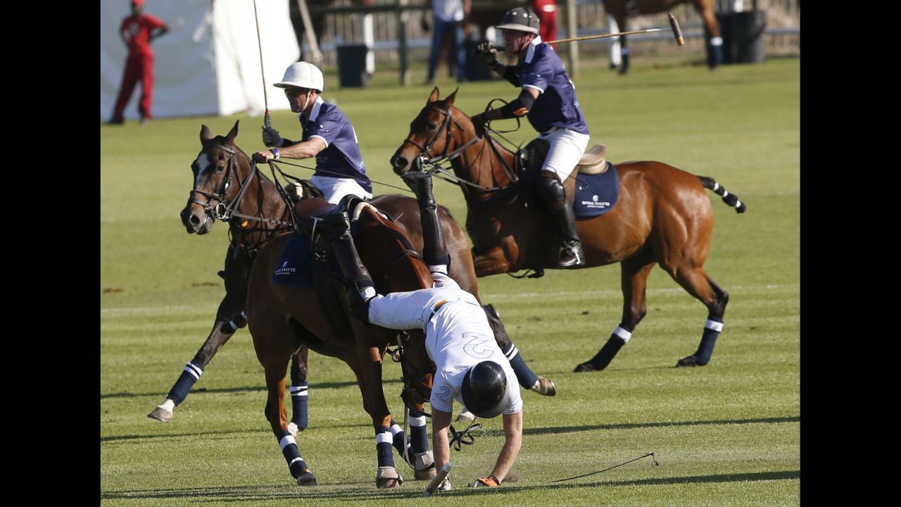 Britain's Prince Harry falls off his horse during a polo match in Paarl, South Africa, on Saturday, November 28.