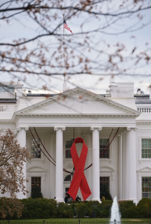 A giant red ribbon is hung on the front of the White House on World Aids Day, on December 1, 2014.
