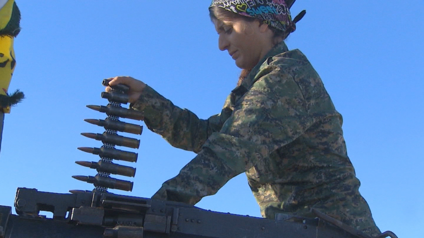 female kurdish soldier loads ammo
