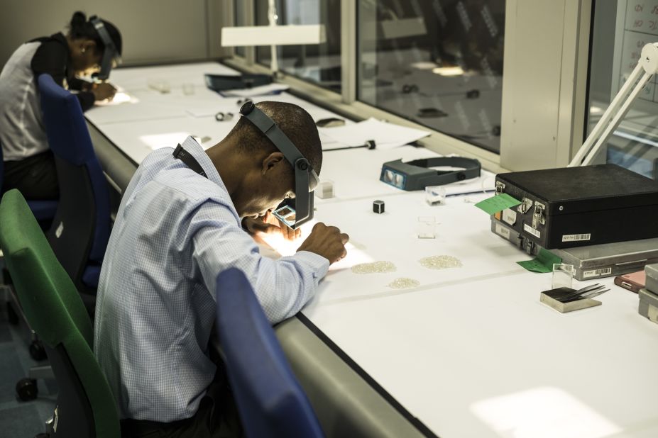 An employee inspects rough diamonds at De Beers' Global Sightholder Sales facility in Gaborone, the largest inspection and valuation operation in the world.