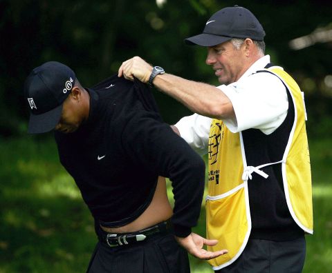 The 14-time major winner has a long history of injury problems. Here he has cream rubbed onto his back by caddy Steve Williams during the 2004 American Express Championship. 