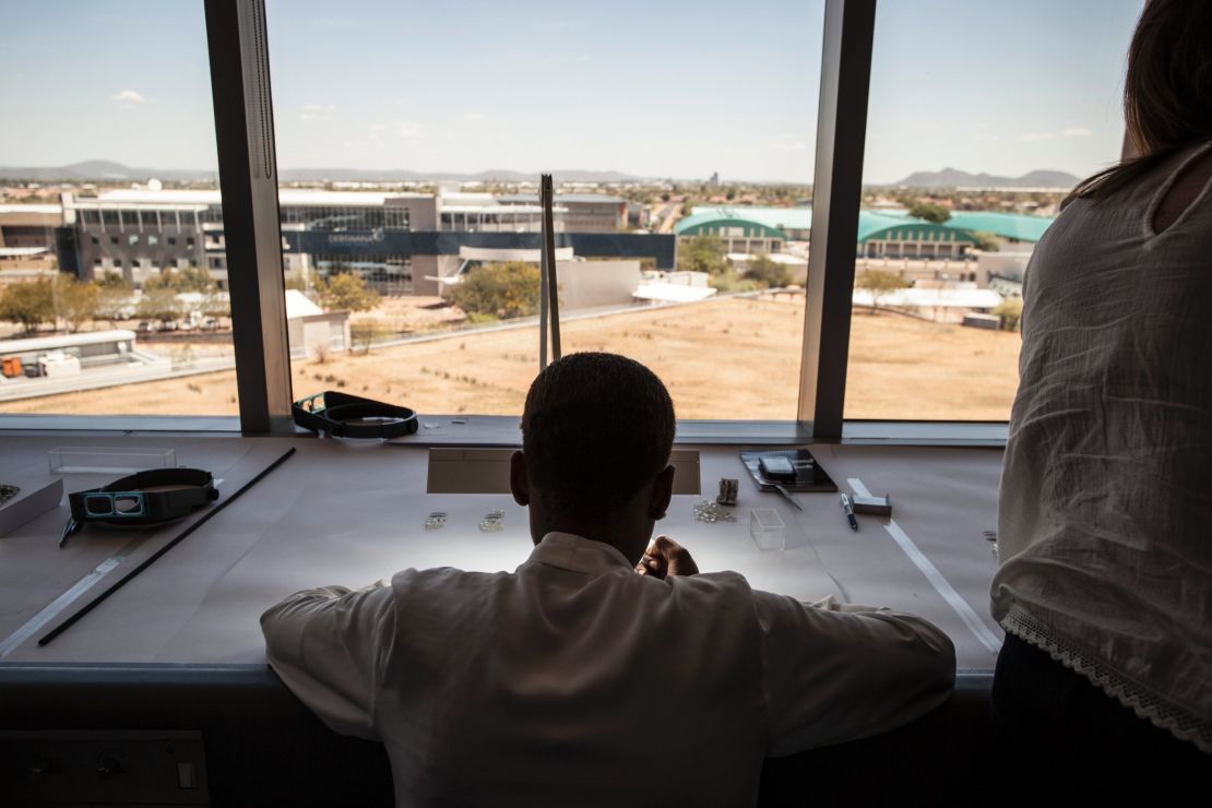 An expert inspects Canadian diamonds at De Beers' Sightholder Sales facility in Gaborone, Botswana