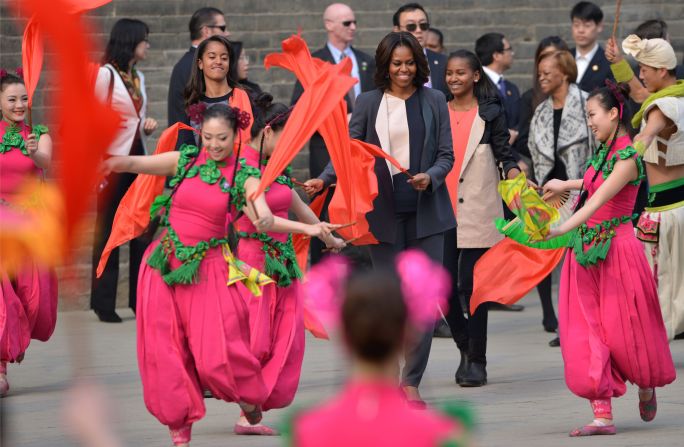 U.S. First Lady Michelle Obama danced with daughters Sasha (right) and Malia (left) during a trip to Xi'an in 2014. "There you stand, on top of a wall that's hundreds of years old -- a wall that has withstood war and famine and the rise and fall of dynasties," she wrote in <a href="https://www.whitehouse.gov/blog/2014/03/24/first-ladys-travel-journal-visiting-xian-city-wall" target="_blank" target="_blank">her travel journal</a>.