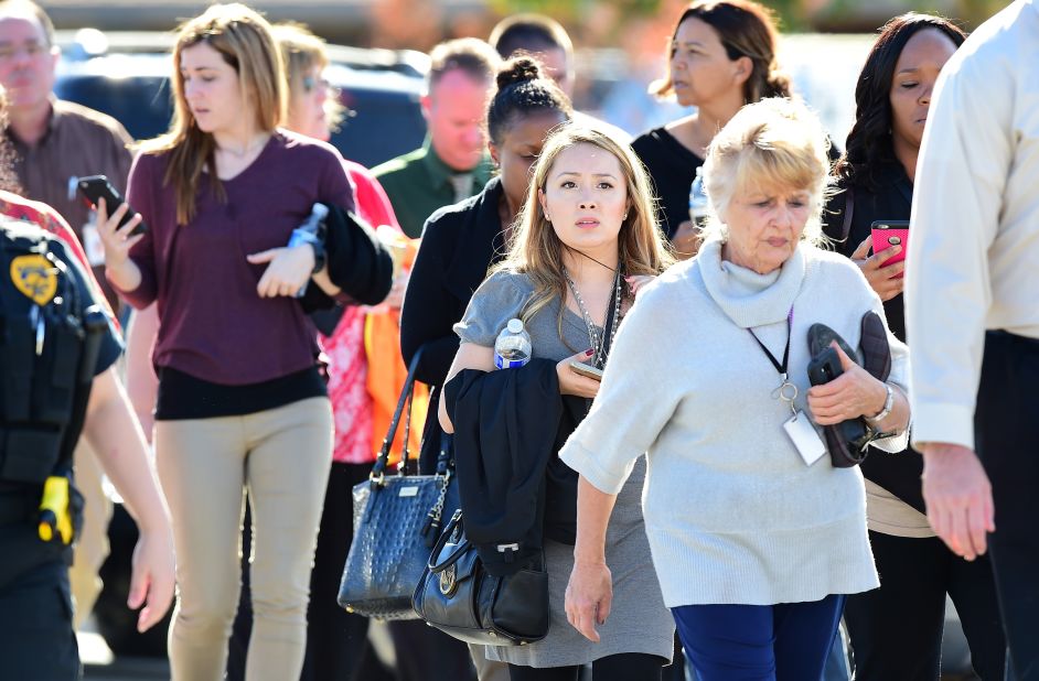 People walk away from the scene. It is unclear how many people were at the facility at the time of the shooting.